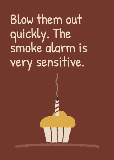 A cupcake with its candles blown out. Blow them out quickly. The smoke alarm is very sensitive.